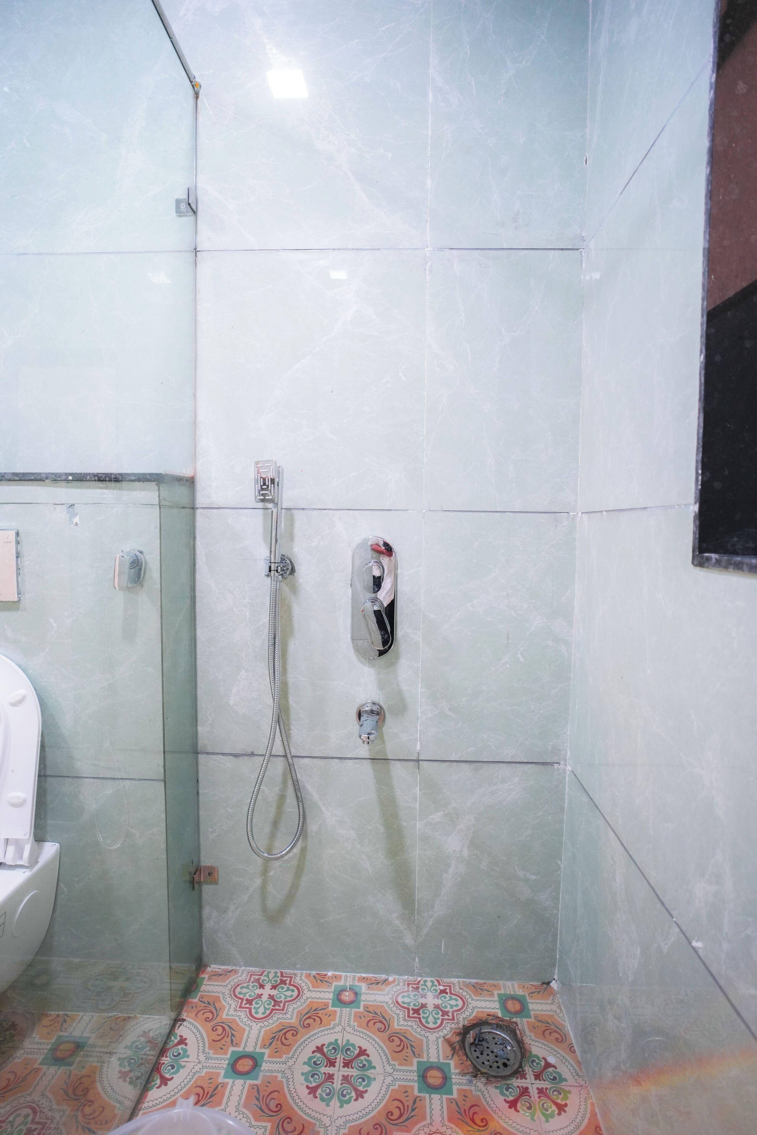 A bathroom with a shower, a toilet, and a sink.