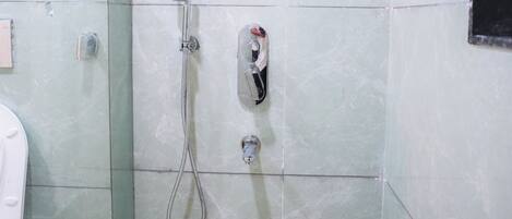 A bathroom with a shower, a toilet, and a sink.