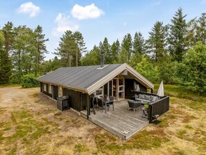 A modern cabin with a deck, outdoor seating, and a large window. - "Pia" - 685m from the sea by Interhome (Læsø)