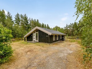 A small, single-story cabin with a sloped roof, surrounded by a natural forest setting. - "Pia" - 685m from the sea by Interhome (Læsø)