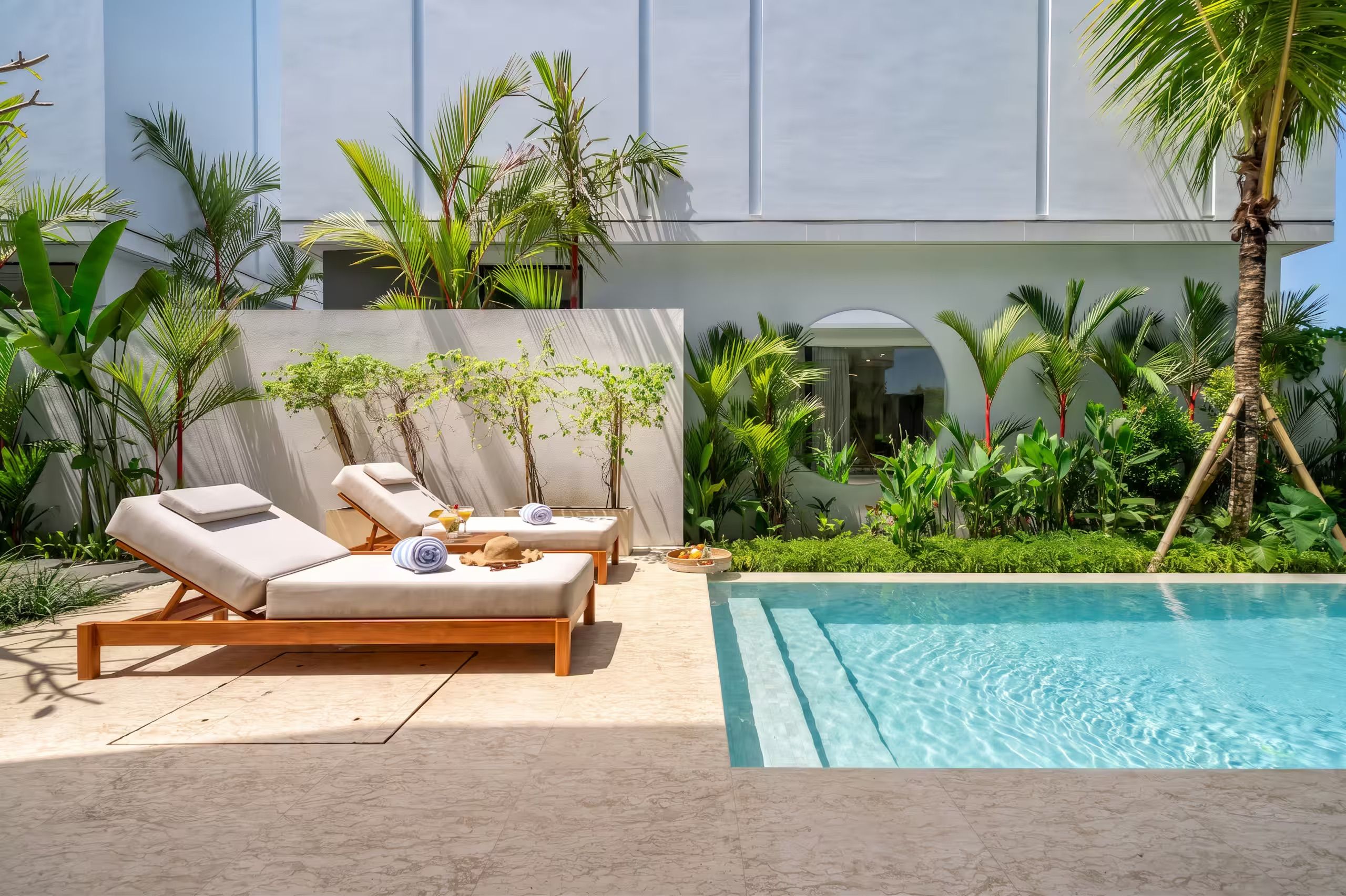 A poolside area with lounge chairs and a swimming pool.