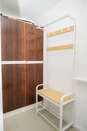 A room with a bunk bed, a wardrobe with a mirror, and a white door.