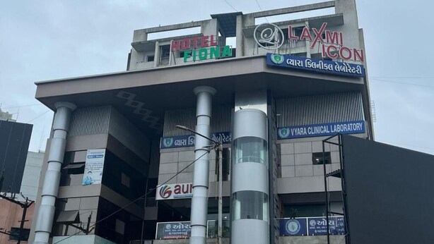 A building with a sign for Hotel Fiona and Laxmi Icon.