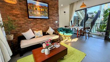 Family Apartment, Balcony, Garden View | Living area | 40-inch flat-screen TV with cable channels