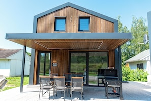 A modern two-story building with a covered patio area. - ARIA Deluxe Mobile home with tickets (Brežice)
