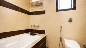 Un baño con bañera, inodoro y ducha.