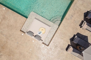 An aerial view of a pool area with a lounge chair, a small table, and a sunbathing area. - Thalelion 3 Bedroom Villas With Private Pool and Jacuzzi (Naxos)