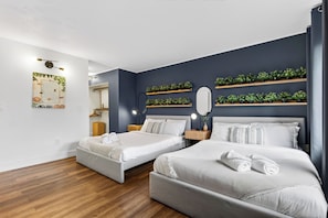 A hotel room with two beds, a mirror, bedside tables, and a wall-mounted shelf with plants. - Garden Balcony + Pool + Deck | Walk to Beach + Dining | Skyline & Salt (Sunny Isles Beach)