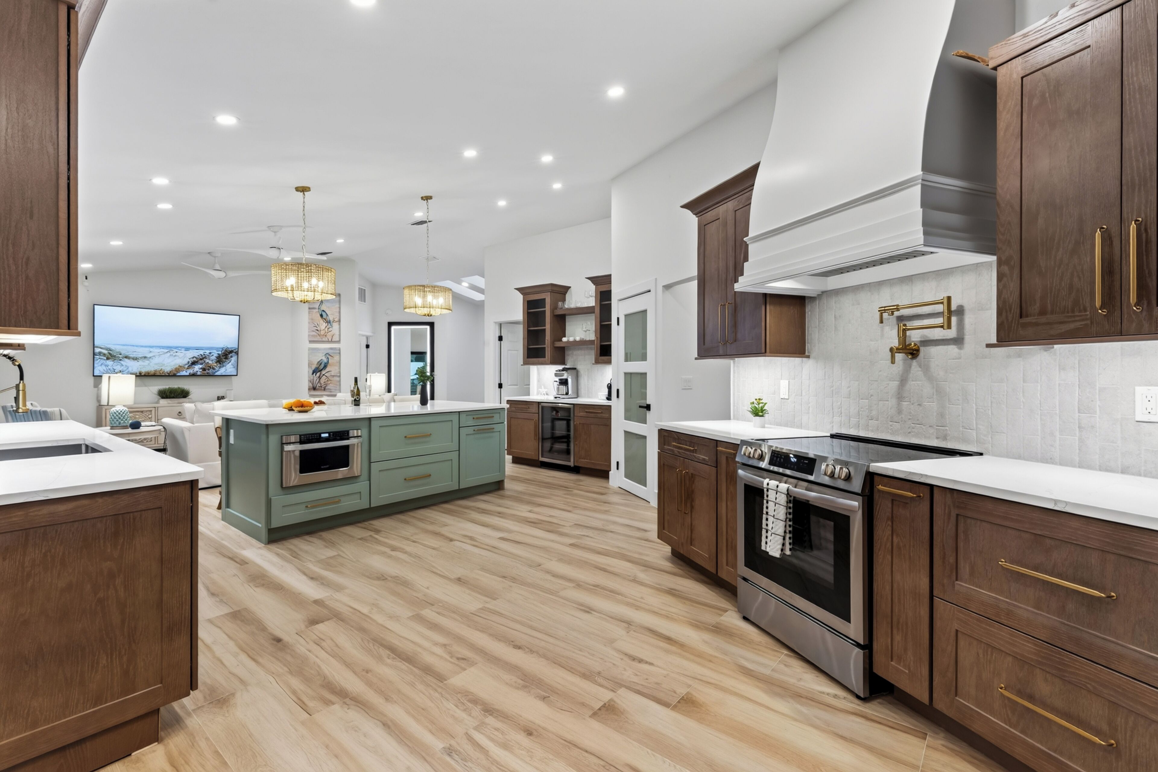 A modern kitchen with wooden cabinets, a central island, and stainless steel appliances.