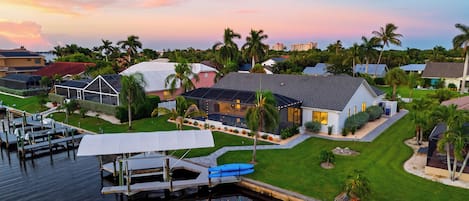 A residential area with houses, a dock, and a calm water body.