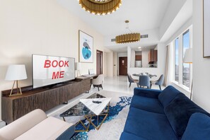 Ein modernes Wohnzimmer mit einer Couch, einem Couchtisch, einem Fernseher und einem Schild mit der Aufschrift 'BOOK ME'.