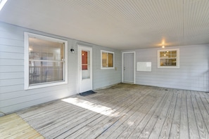 A covered porch with a wooden floor, white exterior walls, and multiple windows with blinds. - 2-Unit Combo 10 Mi to Vintage Park & Airport! (Houston)