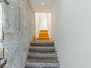 A staircase with stone steps leading to a wooden landing. - Apartment  by Interhome (Porto)