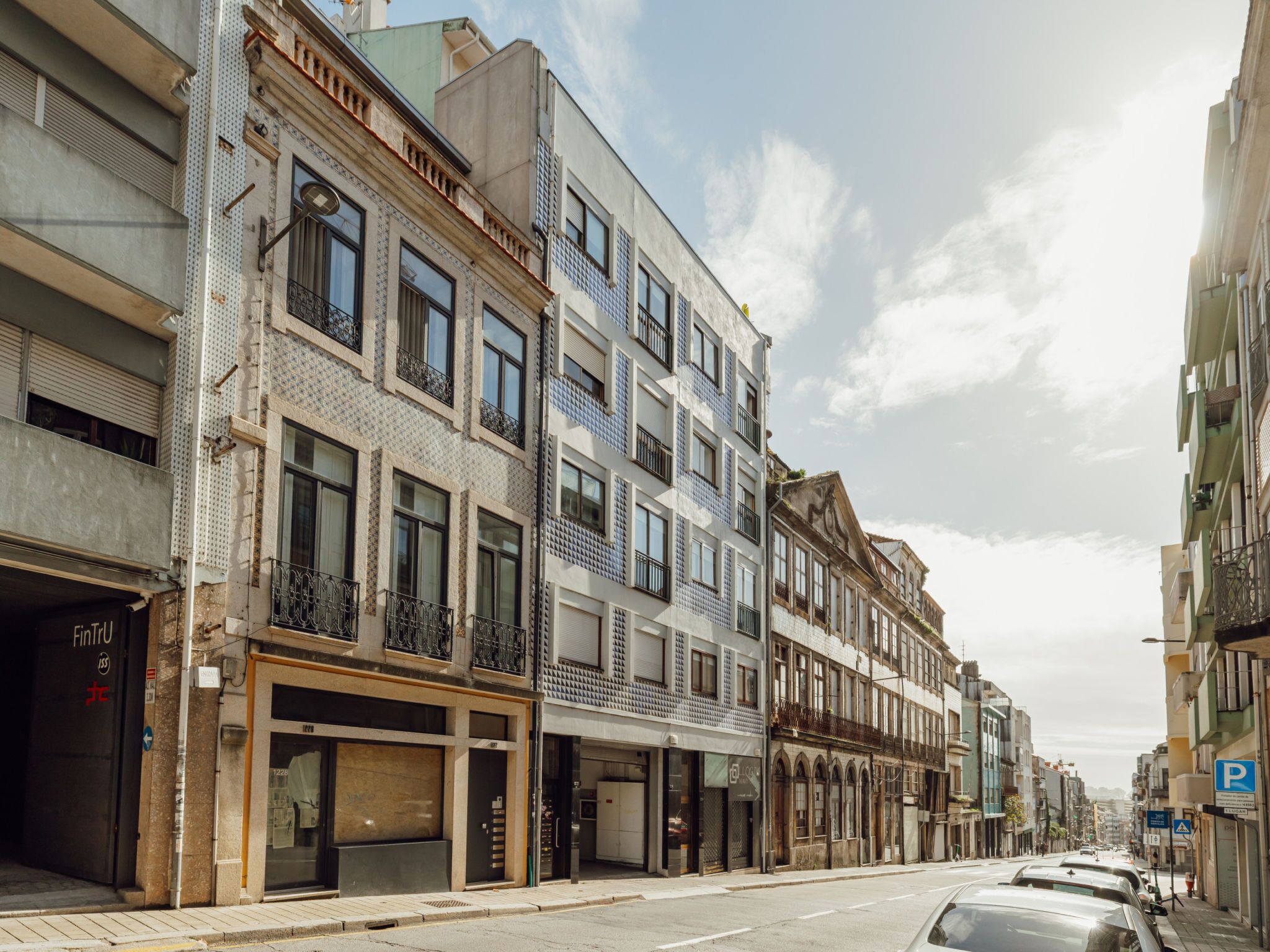 A street with multi-story buildings, some with visible storefronts and signage.