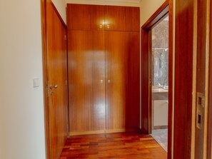 A wooden wardrobe with a mirror and a shower door. - BOTANIC GARDEN TERRACE APARTMENT by VACATIONY by Interhome (Porto)