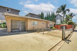 A residential property with a brick exterior, a gated entrance, and a paved driveway. - 2 Mi to Imperial Beach Pier! Extended Stay, Patio (Imperial Beach)