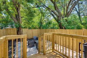 A wooden deck with a built-in seating area and a view of a wooded area. - 3 Mi to Dtwn & EverBank Stadium! Family Townhome (Jacksonville)