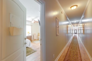 A hallway with a carpeted floor, a ceiling fan, and a door leading to another room. - 1 Mi to Dtwn Sylvester: Studio w/ Shared Fire Pit! (Sylvester)