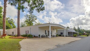 A single-story building with a covered porch and a small attached structure.