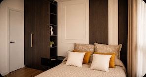 A bedroom with a bed, a wardrobe, and a nightstand.