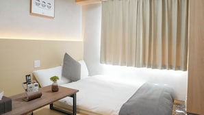 A modern hotel room with a bed, bedside table, lamp, air conditioning unit, and a view of the outdoors. - b&Tsutenkaku 4 (Naniwa Ward,Osaka)