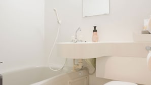 A modern bathroom with a bathtub, toilet, and sink. - b&Tsutenkaku 4 (Naniwa Ward,Osaka)