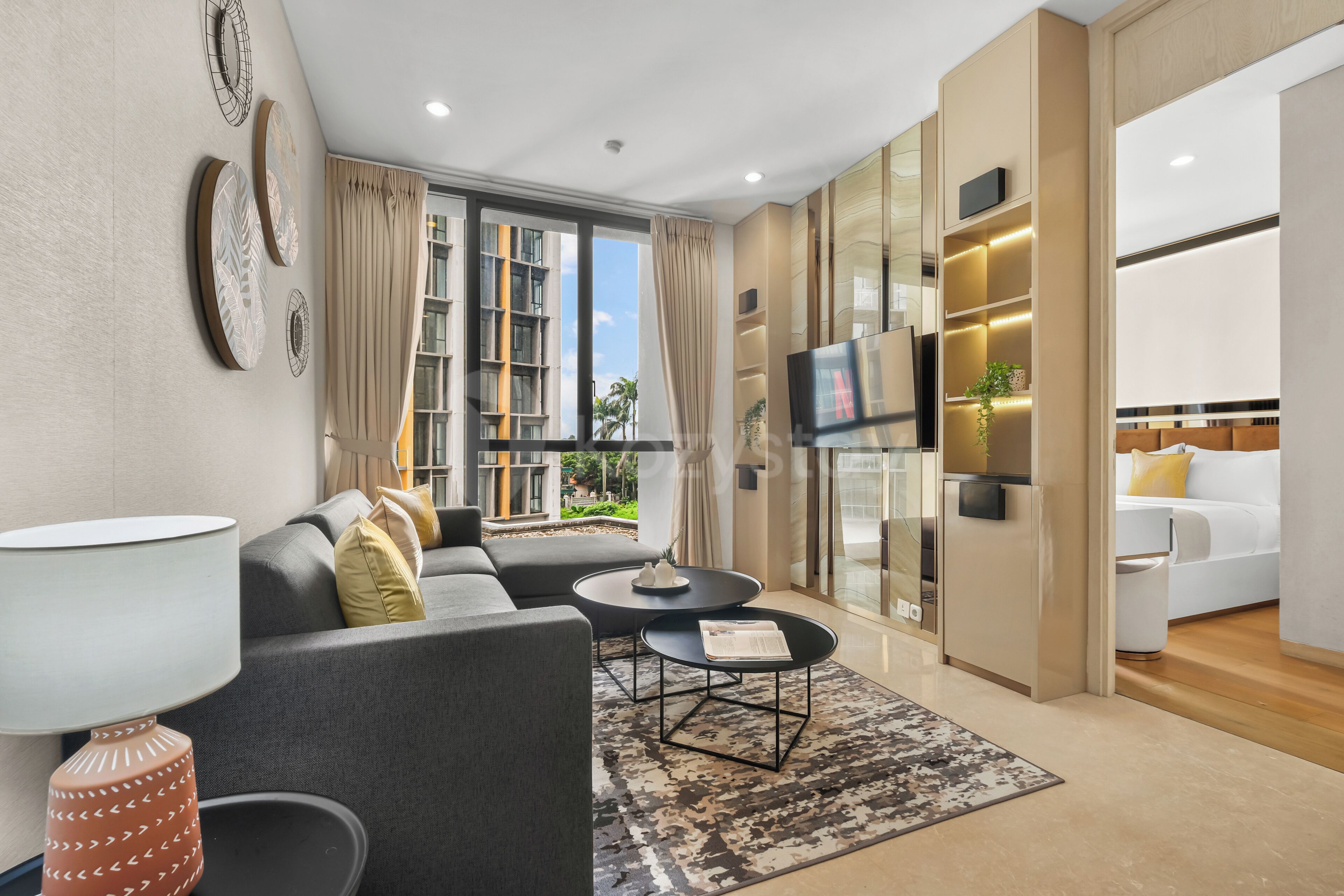 A modern living room with a sofa, coffee table, and a TV.