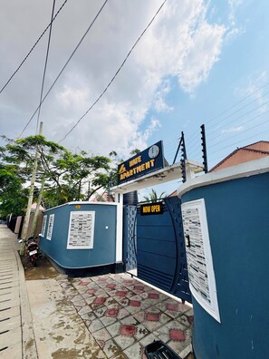 A gated entrance to a property with a sign indicating it's a 'KATE APARTMENT'.