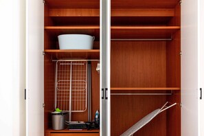 A wooden wardrobe with multiple shelves and a hanging rack. - Veta 31 . 1-BR Apt. & Balcony in Larnaca (Larnaca)