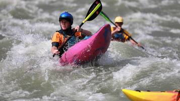 Una persona haciendo kayak en un río.