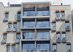 A multi-story building with balconies, large windows, and a modern architectural design. - ICON RESIDENCES Douala (Douala)