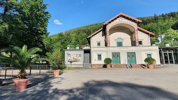 A building with a classic architectural style, featuring a central arched entrance and a symmetrical facade.