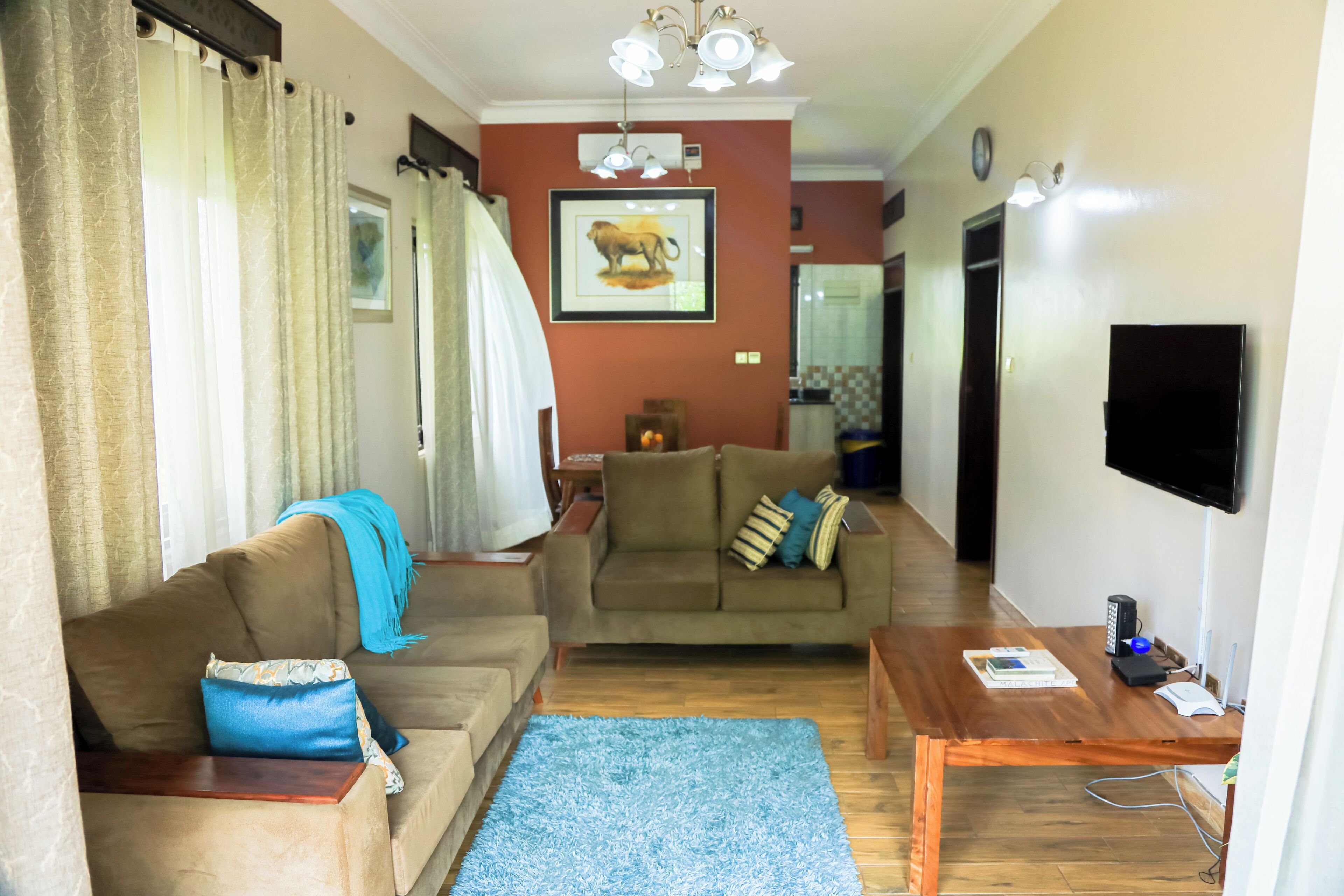 A living room with a sofa, a coffee table, and a television.