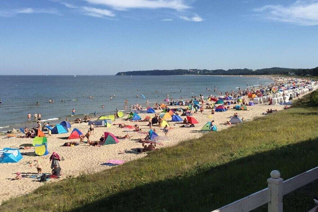 A beach with tents and people.