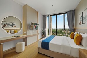 A modern hotel room with a large bed, a desk, a round mirror, and a view of the city through large windows. - Korin by Kozystay - Cilandak (South Jakarta)