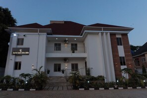 A two-story building with a sign for 'Stallion Luxury Suites.' - Stallion Luxury Suites (Abuja)