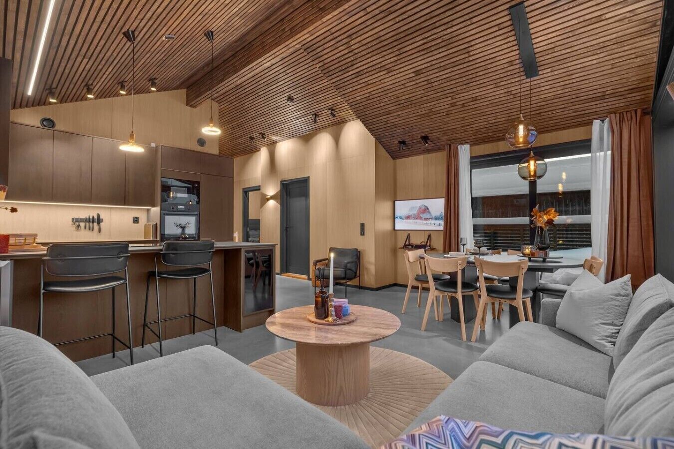 A modern interior with a kitchen, dining area, and living room.