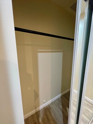 A room with a wooden floor, a white wall, and a black trim. - Brand New Private ADU (Los Angeles)