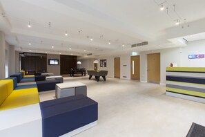 A modern hotel lobby with a pool table, billiards, and a reception desk. - Student Only Selly Oak (Birmingham)