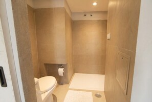 A bathroom with a toilet, a shower, and a bathtub. - Dwell - A place to live (Bengaluru)