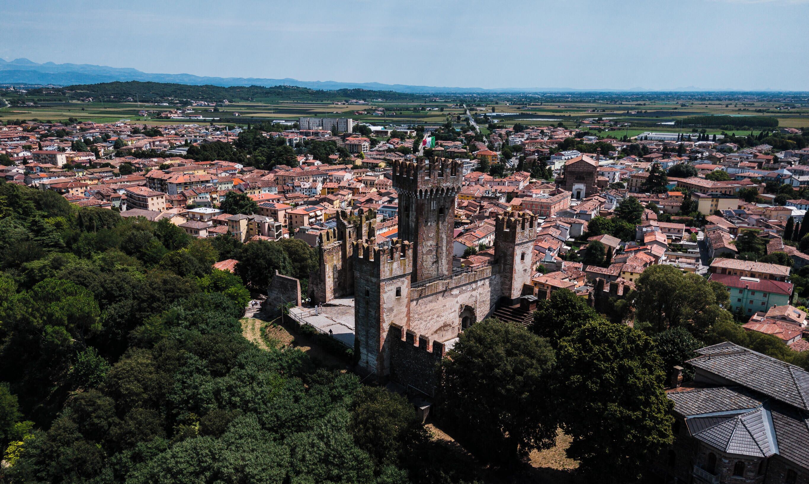 A historic town with a prominent tower and surrounding buildings.