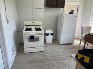 A kitchen with a stove, oven, and refrigerator.