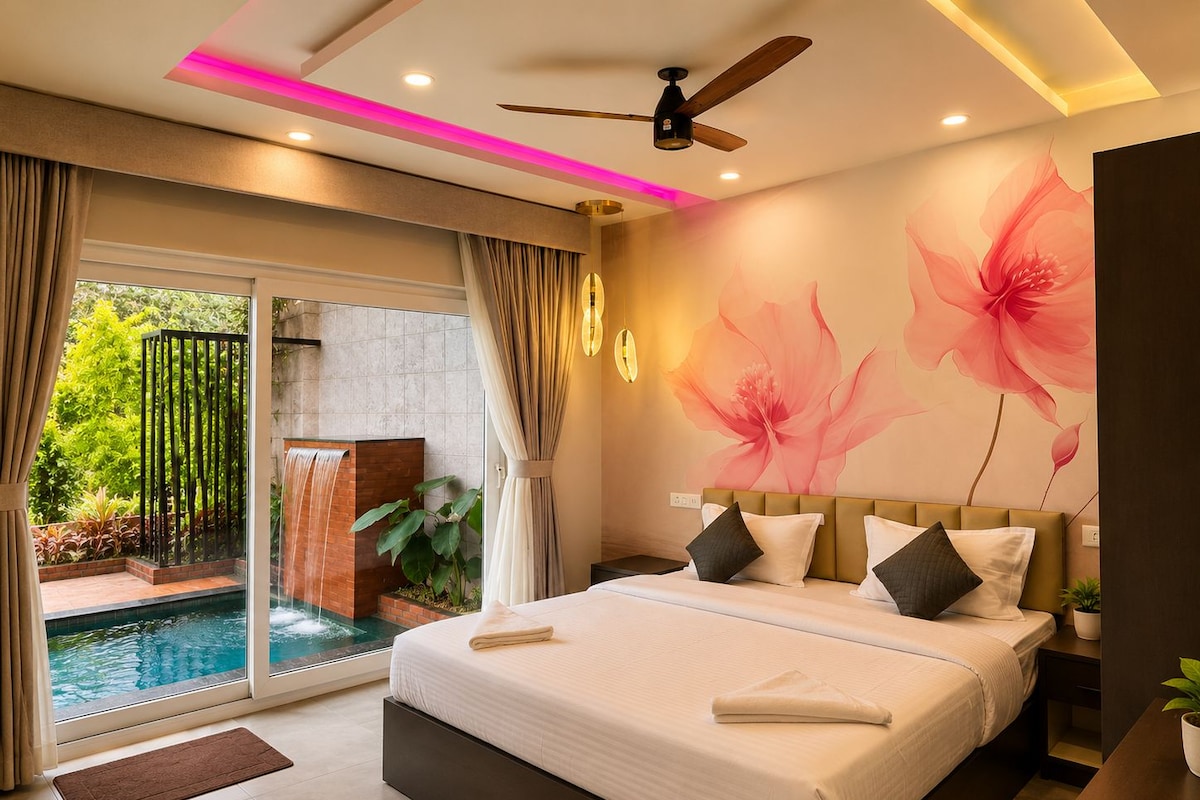 A modern bedroom with a large bed, a ceiling fan, and a view of a swimming pool.