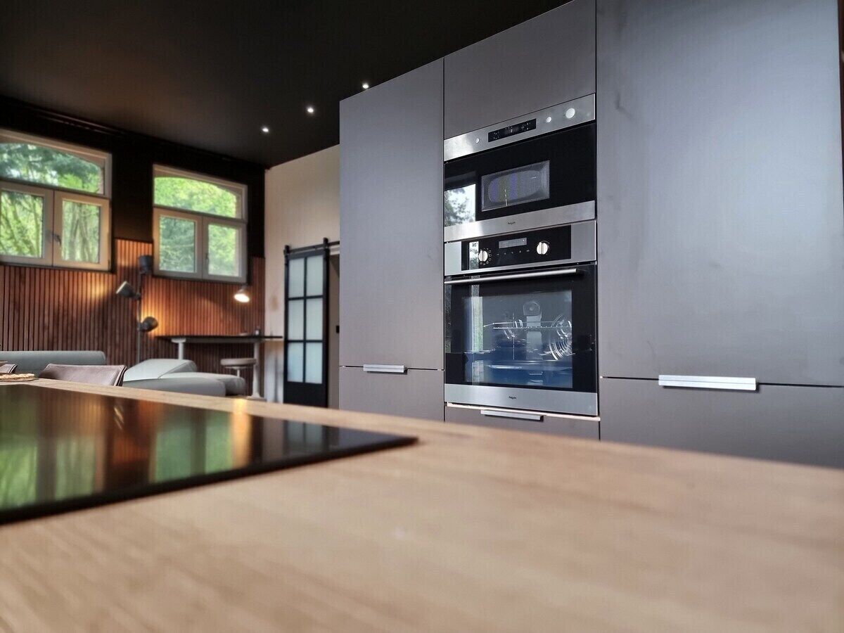 Everyday kitchen equipment with the traditional oven, microwave oven, fridge, freezer, dishwasher, and induction hob.