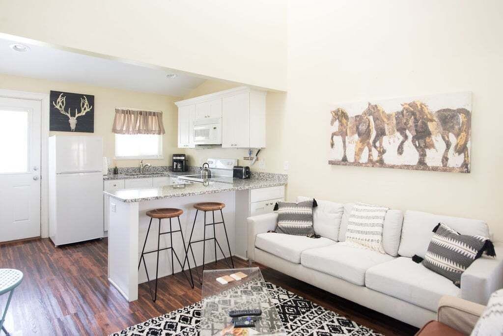 A compact living space with a kitchenette, a sofa, and a coffee table.