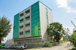 A multi-story building with a modern architectural design, featuring large windows and a flat roof. - Big Z Hote (Addis Ababa)