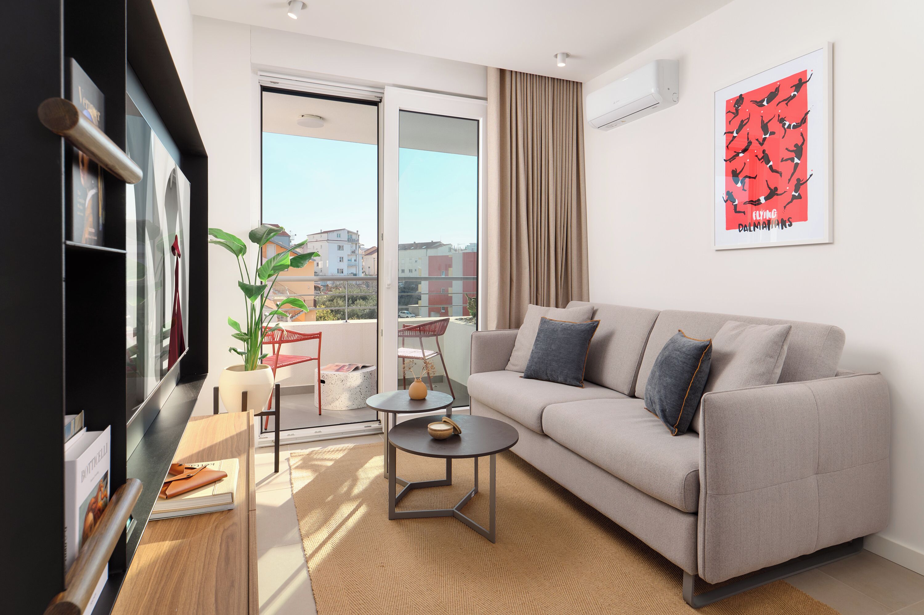A modern living room with a sofa, a coffee table, and a TV.