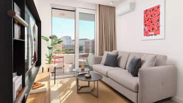 A modern living room with a sofa, a coffee table, and a TV.