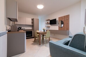 A compact kitchen with modern appliances, a dining area with a table and chairs, and a living space with a sofa. - A welcoming and bright 85 square meters apartment, perfect for six people, located on the third floor of a period building with an elevator (NOT accessible to people with disabilities).The property enjoys an excellent location in Palermo (within the limi (Palermo)