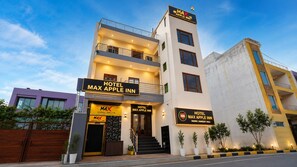 A modern hotel with a prominent sign for 'Hotel Max Apple Inn' and a visible entrance. - Hotel Max Apple In (Agra)